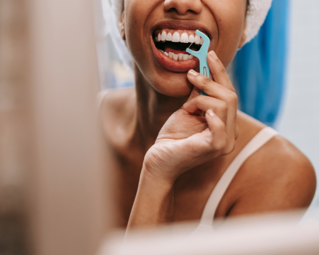 woman flossing teeth
